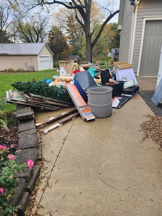 Dumpster being loaded with debris for 12 Yard Dumpster Rental in Claverack
